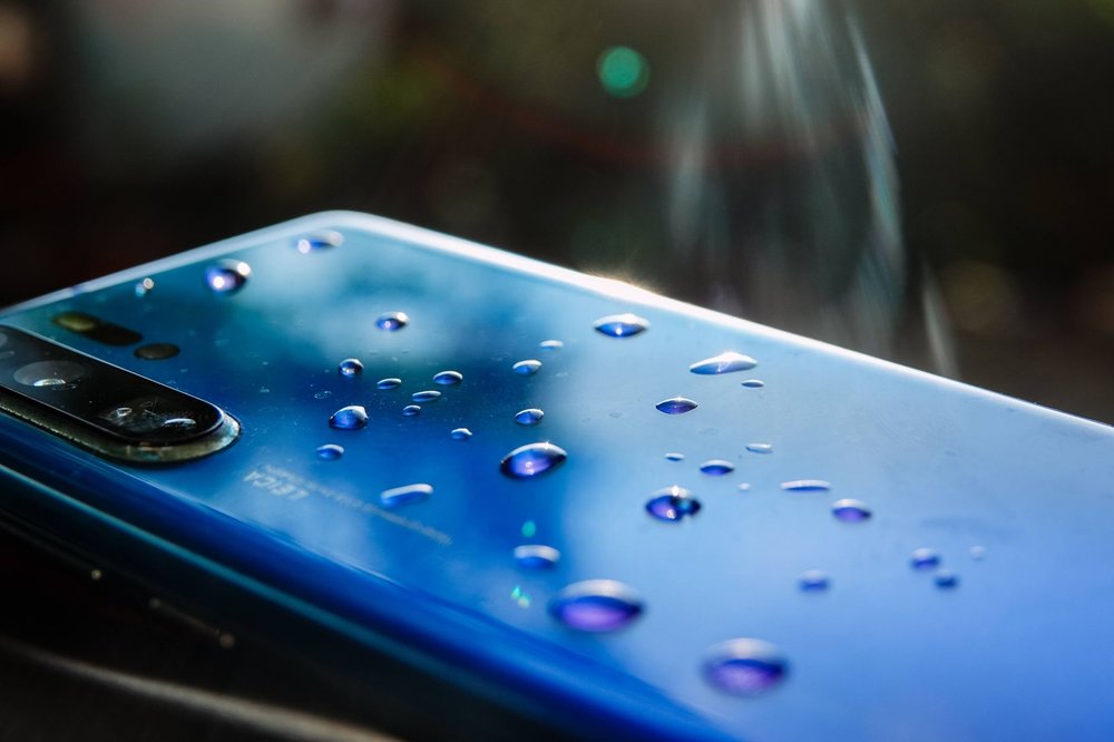 iPhone 16 z kroplami wody na ekranie
